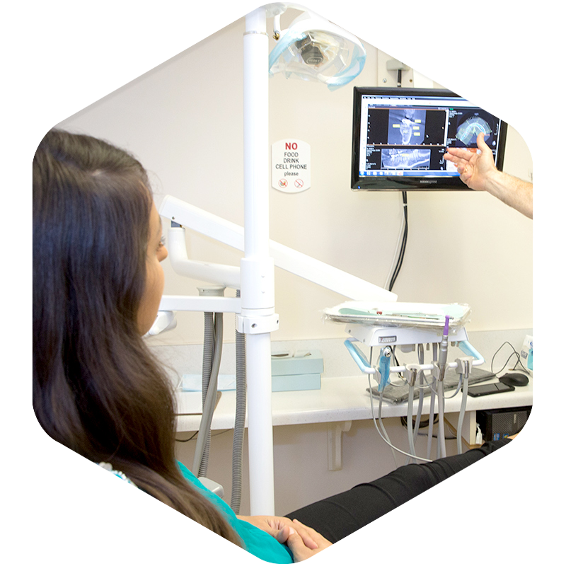 A dentist showing dental X-rays to a patient.
